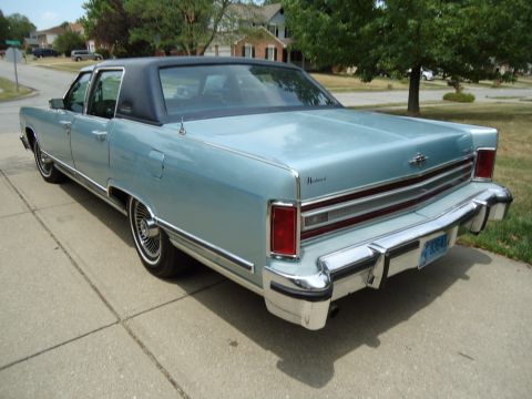 2001 Ford Crown Victoria - Rear view of a light blue 1977 Lincoln Continental Mark IV, a black vinyl roof and chrome bumpers.