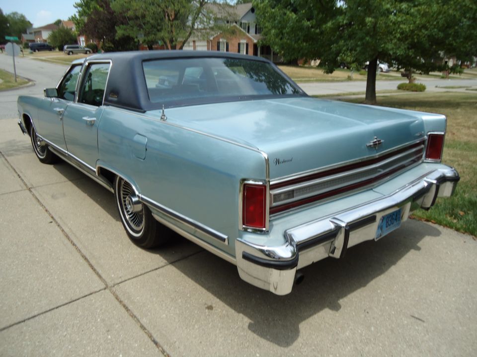 Light blue 1977 Lincoln Continental Mark IV with a black vinyl roof, parked on a driveway
