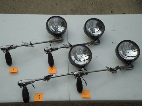 2001 Ford Crown Victoria - Four vintage fog lights are displayed on a table, each marked with a number.