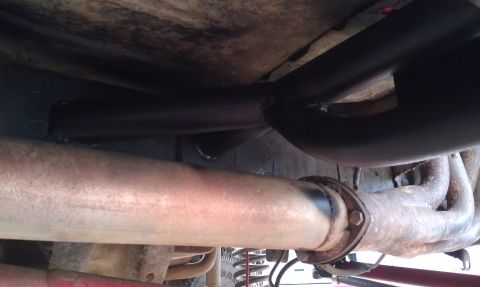1978 Ford Bronco - Underside view of a vehicle's exhaust system, with visible rust and modifications.