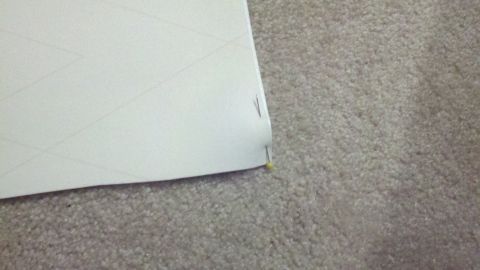 1900 Ford C-350 (Centurion Conversions) - A document with grid lines is pinned to a carpeted surface.