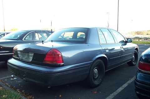 1991 Ford LTD Crown Victoria - Rear view of a blue Ford Crown Victoria, showing its taillights and license plate.