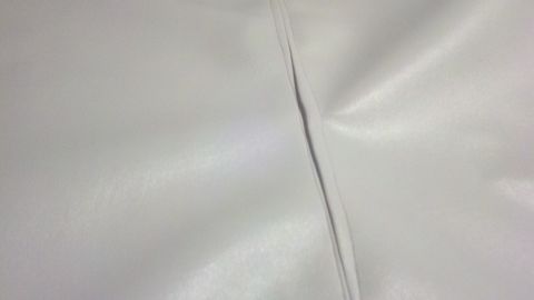 1900 Ford C-350 (Centurion Conversions) - Close-up view of a seam on white interior upholstery.