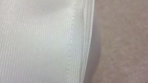 1900 Ford C-350 (Centurion Conversions) - Close-up view of white fabric showing textured weave and stitched seam.