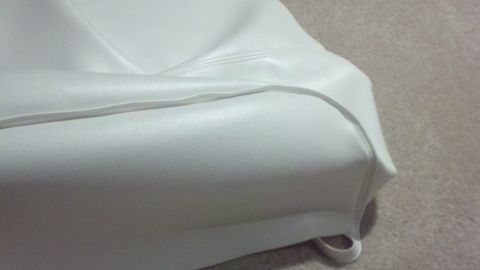 1900 Ford C-350 (Centurion Conversions) - White vinyl seat upholstery detail, likely from a vehicle interior.