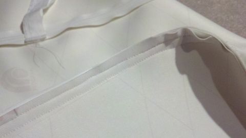 1900 Ford C-350 (Centurion Conversions) - Detail of interior fabric with stitching and a faint pattern. Supermotors logo present.