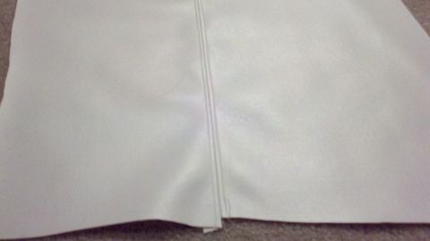 1900 Ford C-350 (Centurion Conversions) - A close-up view of white material with a stitched seam running vertically.