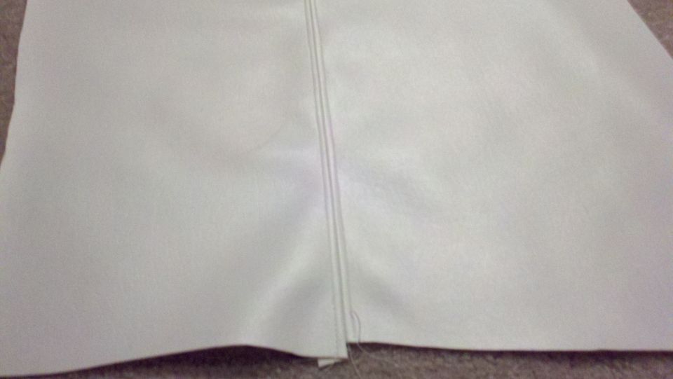 Close-up of white fabric with a prominent vertical seam down the middle