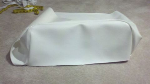 1900 Ford C-350 (Centurion Conversions) - A white vinyl seat cover is shown with a yellow measuring tape and fabric scraps in the background. The registry claims it is a 1900 Ford C…