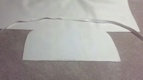 1900 Ford C-350 (Centurion Conversions) - A piece of white fabric with a curved edge and a thin strap is shown.