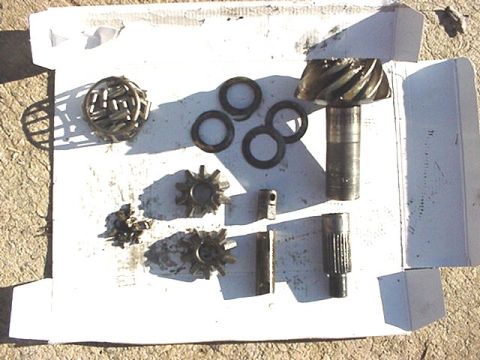 1979 Ford Bronco - Various differential components, including gears and bearings, are arranged on a white surface.