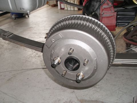 1967 Mercury Cyclone - Close-up of a vehicle's rear brake drum and suspension system, showing mechanical components.