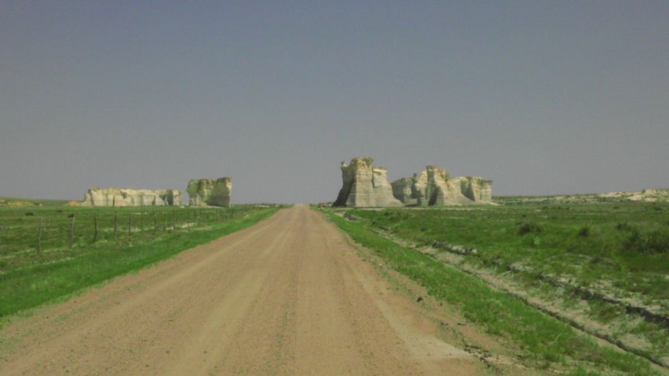 Dirt road leading to rock formations under a clear sky