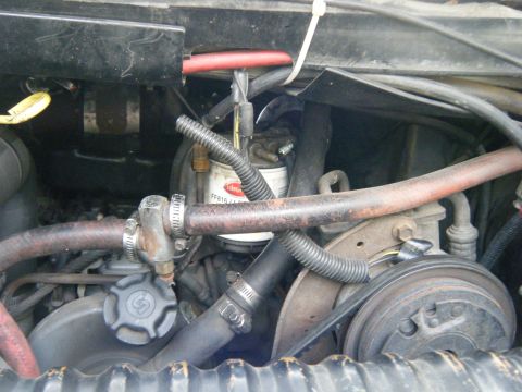 1988 Ford E350 - Engine bay detail with a prominent fuel filter and various hoses and wiring.
