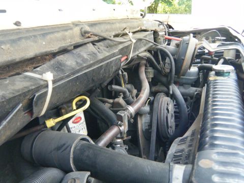 1988 Ford E350 - Close-up view of the engine compartment, showing various mechanical components and hoses.