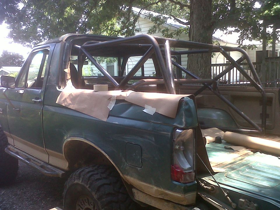 1990 Ford Bronco with custom roll cage installed in the bed and interior
