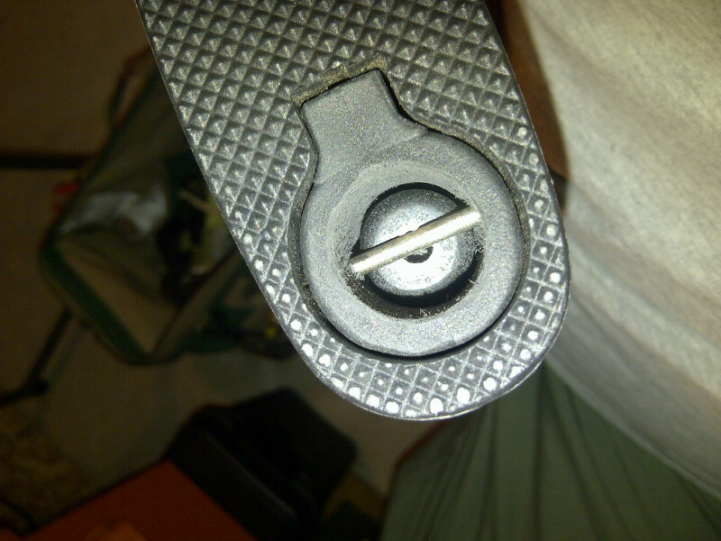 Close-up of a textured part with a circular fastener and pin