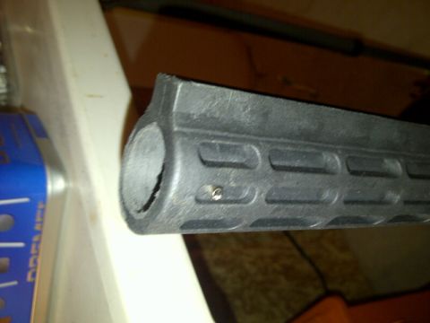 1989 Ford Bronco - Close-up of a black polymer handguard, likely for a firearm, with M-LOK attachment slots.