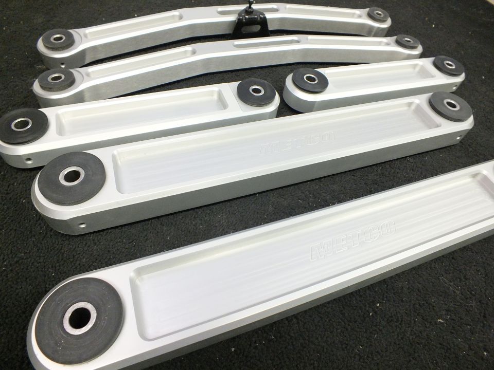 Set of billet aluminum METCO suspension control arms with bushings on carpet
