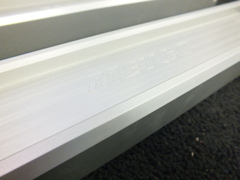2003 Ford Crown Victoria - Macro detail of a machined aluminum control arm, METCO branding stamped into the bar.