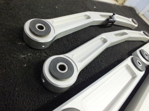 2003 Ford Crown Victoria - Two contoured aluminum suspension arms with bushings and adjuster strap.