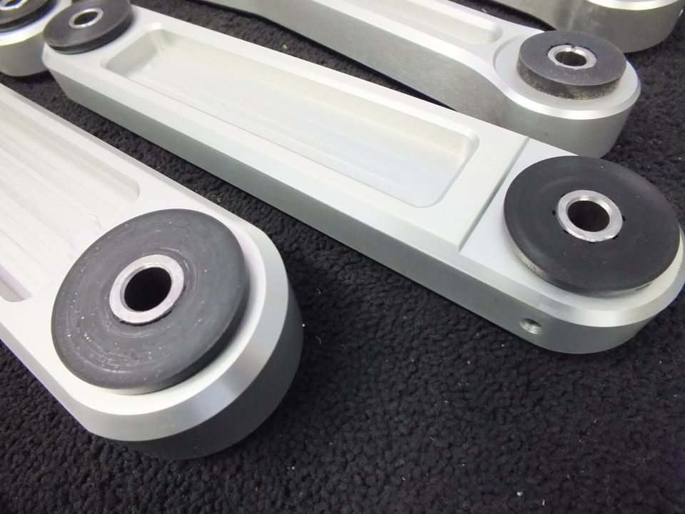 Detail of aluminum control arm bushing ends with rubber inserts on foam