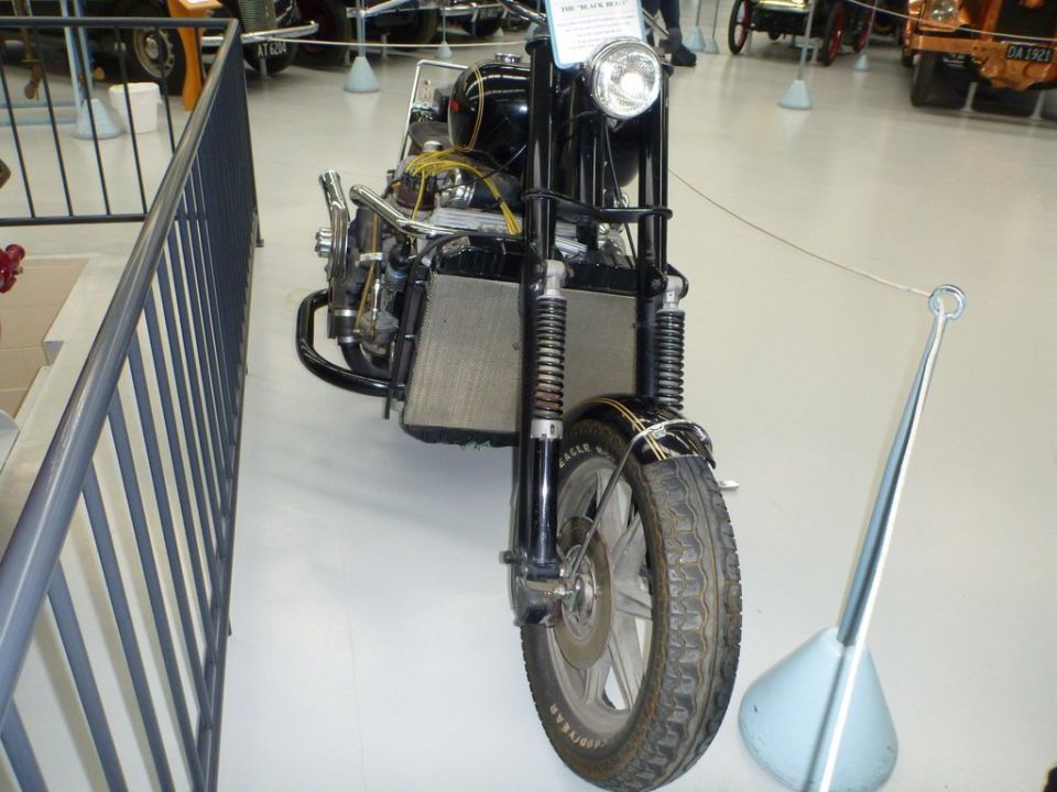 Black motorcycle front view, with chrome accents and a large radiator. The tire has 'GOODYEAR EAGLE' text