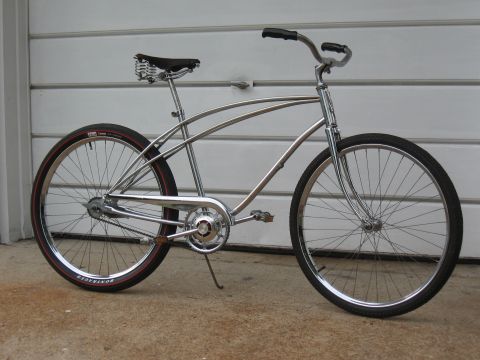 1994 Ford Bronco - This cruiser bicycle has a chrome frame, a spring saddle, and red-striped tires.