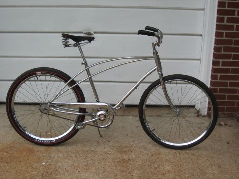 1994 Ford Bronco - A shiny cruiser bicycle with a spring saddle is parked on a concrete surface.