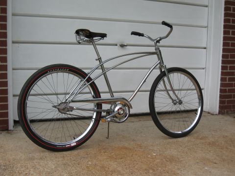 1994 Ford Bronco - A shiny chrome cruiser bicycle is parked in front of a garage door.