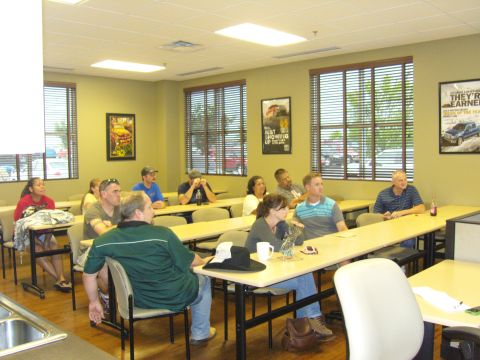 2007 Ford Mustang - A group of people are seated in a classroom setting, attending a meeting or presentation.