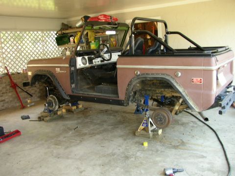 1995 Ford Bronco - This classic Ford Bronco is in a garage, raised on jack stands with its doors removed for maintenance.