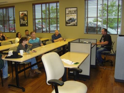 2007 Ford Mustang - People attend a presentation in a classroom with posters on the wall.