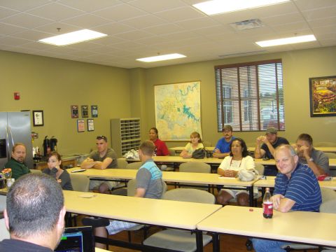 2007 Ford Mustang - A group of people are gathered in a classroom setting, possibly for a meeting or presentation.
