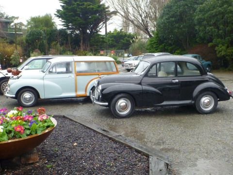1969 Lincoln Continental - Two classic Morris Minor vehicles, a sedan and a Traveller wagon, are parked outdoors.