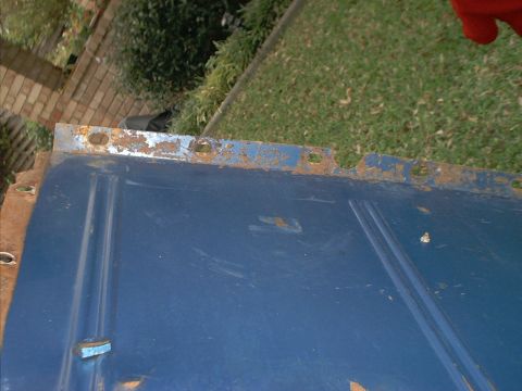 1971 Ford Bronco - Close-up of a blue metal panel showing signs of rust and wear.