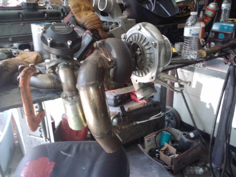 1995 Ford Probe - Close-up of a turbocharger and exhaust manifold assembly, suggesting automotive customization or repair work.