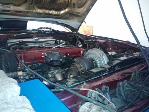 1995 Ford Probe - The engine bay shows a turbocharger and intercooler setup, with the hood open.