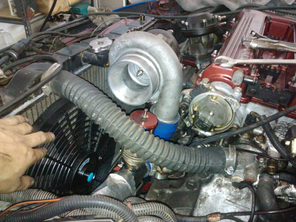 Turbocharger and engine components with a hand near a fan