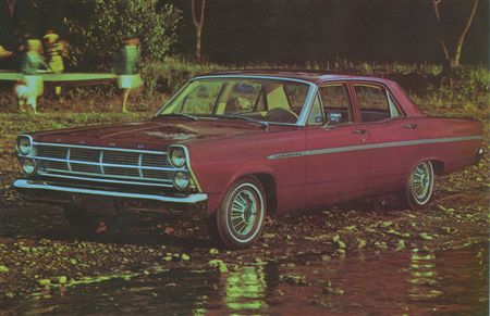 1971 Ford Ranchero - This maroon 1966 Ford Fairlane sedan is parked outdoors on a gravel surface.