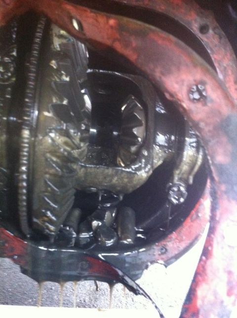 1989 Ford Bronco - This photo shows the internal gears of a vehicle's differential, covered in oil.