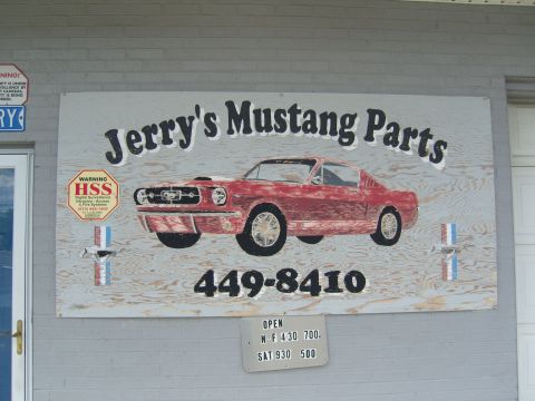 2007 Ford Mustang - A sign advertises Jerry's Mustang Parts, a graphic of a vintage Mustang and business hours.
