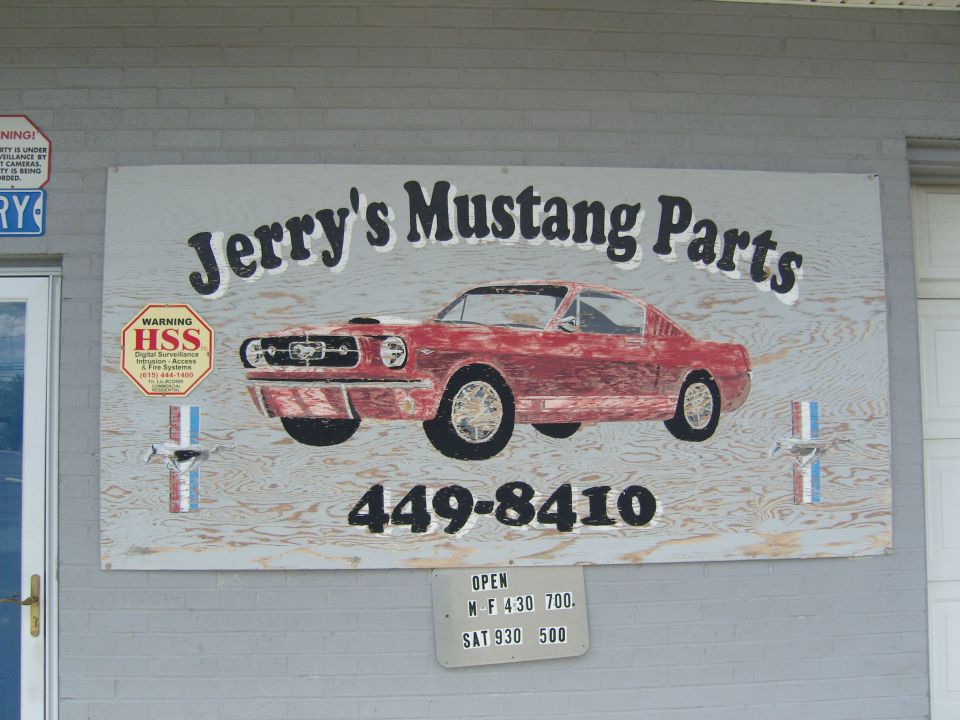 Sign for Jerry's Mustang Parts with a red classic Mustang graphic and phone number 449-8410