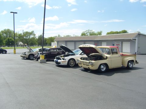 2007 Ford Mustang - Cars with hoods open at a car meet, a classic Ford pickup and a modern Mustang.