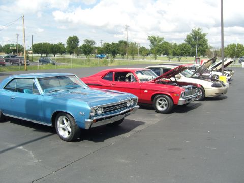 2007 Ford Mustang - A blue 1967 coupe, identified by its body style and SS badging, is parked in a row with several other vehicles at an outdoor event.