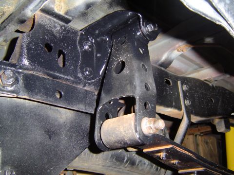 1989 Ford Ranger - Underside view of a truck's suspension bracket and leaf spring attachment point.
