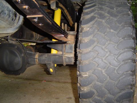 1989 Ford Ranger - This image shows the rear axle, leaf springs, and a large tire of a vehicle, likely an older truck or SUV.