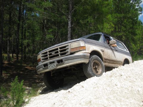 1994 Ford Bronco - This 1994 Ford Bronco navigates a steep, sandy terrain, its off-road capabilities.