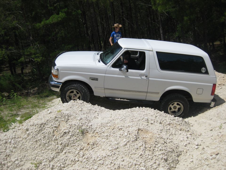 White 1994 Ford Bronco on a dirt pile