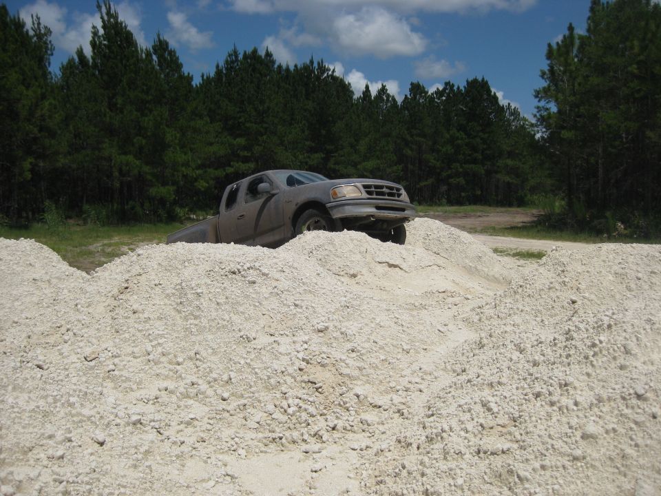 Gray pickup truck on a dirt mound, 1997 model year